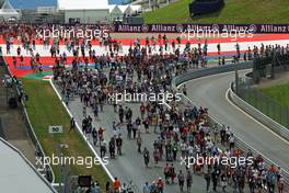 Fans stream down the start / finish straight. 19.06.2014. Formula 1 World Championship, Rd 8, Austrian Grand Prix, Spielberg, Austria, Preparation Day.