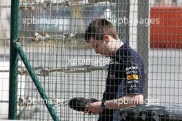 A Red Bull Racing engineer records the engine noises of cars leaving the pits. 19.02.2014. Formula One Testing, Bahrain Test One, Day One, Sakhir, Bahrain.
