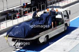 The Scuderia Toro Rosso STR9 of Jean-Eric Vergne (FRA) Scuderia Toro Rosso is recovered back to the pits on the back of a truck. 20.02.2014. Formula One Testing, Bahrain Test One, Day Two, Sakhir, Bahrain.
