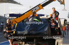 Sebastian Vettel (GER) and his Red Bull Racing RB10 is recovered back to the pits on the back of a truck. 19.02.2014. Formula One Testing, Bahrain Test One, Day One, Sakhir, Bahrain.