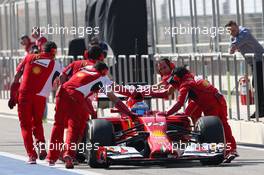 Fernando Alonso (ESP) Ferrari F14-T pushed back by mechanics in the pits. 20.02.2014. Formula One Testing, Bahrain Test One, Day Two, Sakhir, Bahrain.