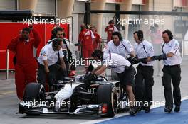 The smoking Sauber C33 of Adrian Sutil (GER) Sauber is pushed down the pit lane by mechanics. 01.03.2014. Formula One Testing, Bahrain Test Two, Day Three, Sakhir, Bahrain.
