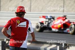 Fernando Alonso (ESP) Ferrari watches team mate Kimi Raikkonen (FIN) Ferrari F14-T on the circuit. 01.03.2014. Formula One Testing, Bahrain Test Two, Day Three, Sakhir, Bahrain.