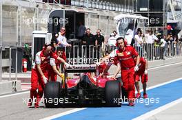 Fernando Alonso (ESP) Ferrari F14-T is pushed back down the pit lane by mechanics. 02.03.2014. Formula One Testing, Bahrain Test Two, Day Four, Sakhir, Bahrain.