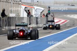 Nico Rosberg (GER), Mercedes AMG F1 Team and Kevin Magnussen (DEN), McLaren F1  27.02.2014. Formula One Testing, Bahrain Test Two, Day One, Sakhir, Bahrain.