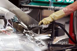 Mercedes AMG F1 W05 pipe attached to engine cover by a mechanic. 27.02.2014. Formula One Testing, Bahrain Test Two, Day One, Sakhir, Bahrain.