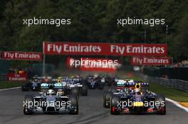 (L to R): Lewis Hamilton (GBR) Mercedes AMG F1 W05 and Sebastian Vettel (GER) Red Bull Racing RB10 battle for position at the start of the race. 24.08.2014. Formula 1 World Championship, Rd 12, Belgian Grand Prix, Spa Francorchamps, Belgium, Race Day.