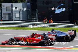 Kimi Raikkonen (FIN) Ferrari F14-T and Jenson Button (GBR) McLaren MP4-29 battle for position. 24.08.2014. Formula 1 World Championship, Rd 12, Belgian Grand Prix, Spa Francorchamps, Belgium, Race Day.