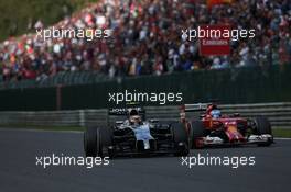 Kevin Magnussen (DEN) McLaren MP4-29 and Fernando Alonso (ESP) Ferrari F14-T battle for position. 24.08.2014. Formula 1 World Championship, Rd 12, Belgian Grand Prix, Spa Francorchamps, Belgium, Race Day.