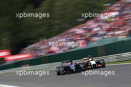 Jenson Button (GBR) McLaren MP4-29 and Sergio Perez (MEX) Sahara Force India F1 VJM07 battle for position. 24.08.2014. Formula 1 World Championship, Rd 12, Belgian Grand Prix, Spa Francorchamps, Belgium, Race Day.