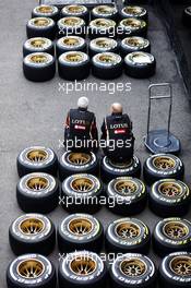 Lotus F1 Team mechanics sit on Pirelli tyres. 21.08.2014. Formula 1 World Championship, Rd 12, Belgian Grand Prix, Spa Francorchamps, Belgium, Preparation Day.