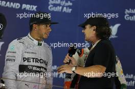 Race winner Lewis Hamilton (GBR) Mercedes AMG F1 on the podium with Brian Johnson (GBR) AC/DC Lead Singer. 06.04.2014. Formula 1 World Championship, Rd 3, Bahrain Grand Prix, Sakhir, Bahrain, Race Day.