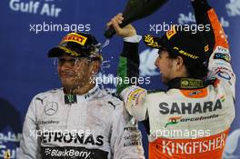 The podium (L to R): Race winner Lewis Hamilton (GBR) Mercedes AMG F1 celebrates with third placed Sergio Perez (MEX) Sahara Force India F1. 06.04.2014. Formula 1 World Championship, Rd 3, Bahrain Grand Prix, Sakhir, Bahrain, Race Day.