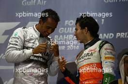 Lewis Hamilton (GBR) Mercedes AMG F1 and Sergio Perez (MEX) Sahara Force India F1. 06.04.2014. Formula 1 World Championship, Rd 3, Bahrain Grand Prix, Sakhir, Bahrain, Race Day.