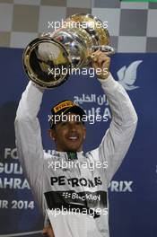 Race winner Lewis Hamilton (GBR) Mercedes AMG F1 celebrates on the podium. 06.04.2014. Formula 1 World Championship, Rd 3, Bahrain Grand Prix, Sakhir, Bahrain, Race Day.