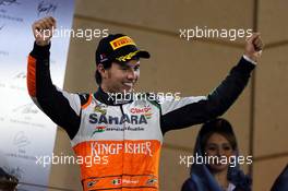Sergio Perez (MEX) Sahara Force India F1 celebrates his third position on the podium. 06.04.2014. Formula 1 World Championship, Rd 3, Bahrain Grand Prix, Sakhir, Bahrain, Race Day.
