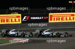 Nico Rosberg (GER) Mercedes AMG F1 W05 and Lewis Hamilton (GBR) Mercedes AMG F1 W05 battle for position. 06.04.2014. Formula 1 World Championship, Rd 3, Bahrain Grand Prix, Sakhir, Bahrain, Race Day.