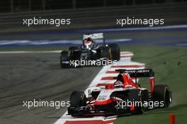 Jules Bianchi (FRA) Marussia F1 Team MR03 runs wide ahead of Adrian Sutil (GER) Sauber C33. 06.04.2014. Formula 1 World Championship, Rd 3, Bahrain Grand Prix, Sakhir, Bahrain, Race Day.