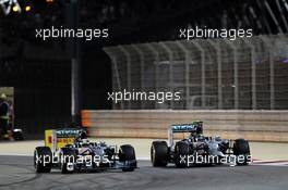 (L to R): Lewis Hamilton (GBR) Mercedes AMG F1 W05 and team mate Nico Rosberg (GER) Mercedes AMG F1 W05 battle for position. 06.04.2014. Formula 1 World Championship, Rd 3, Bahrain Grand Prix, Sakhir, Bahrain, Race Day.