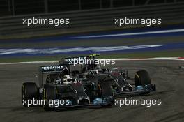 Lewis Hamilton (GBR) Mercedes AMG F1 W05 and team mate Nico Rosberg (GER) Mercedes AMG F1 W05 battle for position. 06.04.2014. Formula 1 World Championship, Rd 3, Bahrain Grand Prix, Sakhir, Bahrain, Race Day.