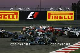 Lewis Hamilton (GBR) Mercedes AMG F1 W05 leads Nico Rosberg (GER) Mercedes AMG F1 W05 at the start of the race. 06.04.2014. Formula 1 World Championship, Rd 3, Bahrain Grand Prix, Sakhir, Bahrain, Race Day.