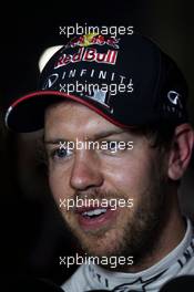 Sebastian Vettel (GER) Red Bull Racing with the media. 05.04.2014. Formula 1 World Championship, Rd 3, Bahrain Grand Prix, Sakhir, Bahrain, Qualifying Day.