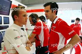 Max Chilton (GBR) Marussia F1 Team with Marc Hynes (GBR) Marussia F1 Team Driver Coach. 05.04.2014. Formula 1 World Championship, Rd 3, Bahrain Grand Prix, Sakhir, Bahrain, Qualifying Day.