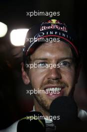 Sebastian Vettel (GER) Red Bull Racing with the media. 05.04.2014. Formula 1 World Championship, Rd 3, Bahrain Grand Prix, Sakhir, Bahrain, Qualifying Day.