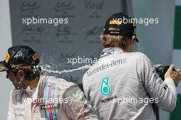 (L to R): third placed Felipe Massa (BRA) Williams and race winner Nico Rosberg (GER) Mercedes AMG F1 celebrate on the podium. 09.11.2014. Formula 1 World Championship, Rd 18, Brazilian Grand Prix, Sao Paulo, Brazil, Race Day.