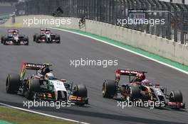(L to R): Sergio Perez (MEX) Sahara Force India F1 VJM07 and Romain Grosjean (FRA) Lotus F1 E22 battle for position. 09.11.2014. Formula 1 World Championship, Rd 18, Brazilian Grand Prix, Sao Paulo, Brazil, Race Day.