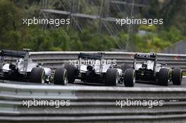 Kevin Magnussen (DEN) McLaren MP4-29; Nico Rosberg (GER) Mercedes AMG F1 W05; and Lewis Hamilton (GBR) Mercedes AMG F1 W05. 09.11.2014. Formula 1 World Championship, Rd 18, Brazilian Grand Prix, Sao Paulo, Brazil, Race Day.