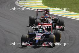 Jean-Eric Vergne (FRA) Scuderia Toro Rosso STR9 leads Romain Grosjean (FRA) Lotus F1 E22. 09.11.2014. Formula 1 World Championship, Rd 18, Brazilian Grand Prix, Sao Paulo, Brazil, Race Day.