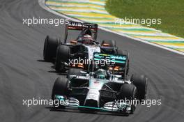 Nico Rosberg (GER) Mercedes AMG F1 W05 leads Nico Hulkenberg (GER) Sahara Force India F1 VJM07. 09.11.2014. Formula 1 World Championship, Rd 18, Brazilian Grand Prix, Sao Paulo, Brazil, Race Day.