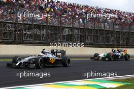 Kevin Magnussen (DEN) McLaren MP4-29 leads Nico Hulkenberg (GER) Sahara Force India F1 VJM07. 09.11.2014. Formula 1 World Championship, Rd 18, Brazilian Grand Prix, Sao Paulo, Brazil, Race Day.