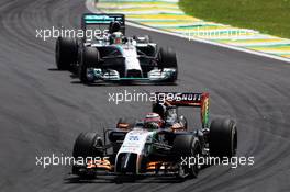 Nico Hulkenberg (GER) Sahara Force India F1 VJM07 leads Lewis Hamilton (GBR) Mercedes AMG F1 W05. 09.11.2014. Formula 1 World Championship, Rd 18, Brazilian Grand Prix, Sao Paulo, Brazil, Race Day.