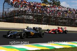 Kevin Magnussen (DEN) McLaren MP4-29 leads Fernando Alonso (ESP) Ferrari F14-T. 09.11.2014. Formula 1 World Championship, Rd 18, Brazilian Grand Prix, Sao Paulo, Brazil, Race Day.