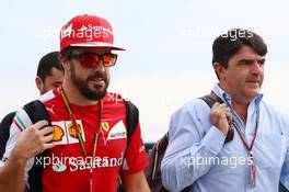 Fernando Alonso (ESP) Ferrari with Luis Garcia Abad (ESP) Driver Manager. 08.11.2014. Formula 1 World Championship, Rd 18, Brazilian Grand Prix, Sao Paulo, Brazil, Qualifying Day.
