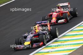 Sebastian Vettel (GER) Red Bull Racing RB10 leads Kimi Raikkonen (FIN) Ferrari F14-T. 08.11.2014. Formula 1 World Championship, Rd 18, Brazilian Grand Prix, Sao Paulo, Brazil, Qualifying Day.