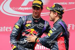 Race winner Daniel Ricciardo (AUS) Red Bull Racing celebrates with team mate Sebastian Vettel (GER) Red Bull Racing on the podium. 08.06.2014. Formula 1 World Championship, Rd 7, Canadian Grand Prix, Montreal, Canada, Race Day.