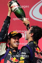 Race winner Daniel Ricciardo (AUS) Red Bull Racing celebrates with team mate Sebastian Vettel (GER) Red Bull Racing on the podium. 08.06.2014. Formula 1 World Championship, Rd 7, Canadian Grand Prix, Montreal, Canada, Race Day.