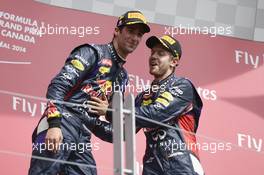 (L to R): Race winner Sebastian Vettel (GER) Red Bull Racing celebrates on the podium with third placed team mate Sebastian Vettel (GER) Red Bull Racing on the podium. 08.06.2014. Formula 1 World Championship, Rd 7, Canadian Grand Prix, Montreal, Canada, Race Day.