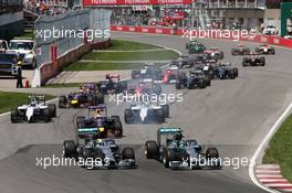 (L to R): Lewis Hamilton (GBR) Mercedes AMG F1 W05 and team mate Nico Rosberg (GER) Mercedes AMG F1 W05 battle for the lead at the start of the race. 08.06.2014. Formula 1 World Championship, Rd 7, Canadian Grand Prix, Montreal, Canada, Race Day.