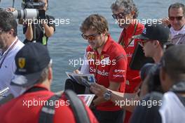 Fernando Alonso (ESP) Ferrari signs autographs for the fans. 08.06.2014. Formula 1 World Championship, Rd 7, Canadian Grand Prix, Montreal, Canada, Race Day.