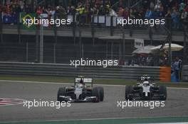 Esteban Gutierrez (MEX) Sauber C33 and Kevin Magnussen (DEN) McLaren MP4-29 battle for position. 20.04.2014. Formula 1 World Championship, Rd 4, Chinese Grand Prix, Shanghai, China, Race Day.