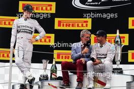 (L to R): Nico Rosberg (GER) Mercedes AMG F1 on the podium with Eddie Jordan (IRE) BBC Television Pundit and race winner Lewis Hamilton (GBR) Mercedes AMG F1. 11.05.2014. Formula 1 World Championship, Rd 5, Spanish Grand Prix, Barcelona, Spain, Race Day.