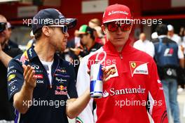 (L to R): Sebastian Vettel (GER) Red Bull Racing with Kimi Raikkonen (FIN) Ferrari on the drivers parade. 11.05.2014. Formula 1 World Championship, Rd 5, Spanish Grand Prix, Barcelona, Spain, Race Day.