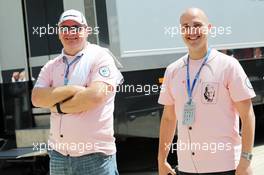 Fans in the paddock wear Pink for Papa clothing in memory of John Button (GBR), the late father of Jenson Button (GBR) McLaren. 04.07.2014. Formula 1 World Championship, Rd 9, British Grand Prix, Silverstone, England, Practice Day.