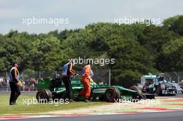 Marcus Ericsson (SWE) Caterham CT05 spins and stops during FP1, passed by Nico Rosberg (GER) Mercedes AMG F1 W05. 04.07.2014. Formula 1 World Championship, Rd 9, British Grand Prix, Silverstone, England, Practice Day.