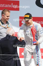 Valtteri Bottas (FIN) Williams celebrates his second position on the podium with John Surtees (GBR). 06.07.2014. Formula 1 World Championship, Rd 9, British Grand Prix, Silverstone, England, Race Day.