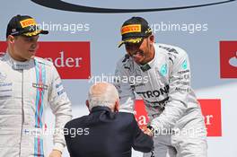 Race winner Lewis Hamilton (GBR) Mercedes AMG F1 celebrates on the podium with John Surtees (GBR). 06.07.2014. Formula 1 World Championship, Rd 9, British Grand Prix, Silverstone, England, Race Day.